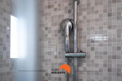 a shower in a bathroom with a tiled wall at #232 Vila Girasol 33 by Home Holidays in Albufeira