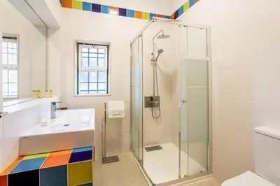 a bathroom with a shower and a sink at Villa Moura by HelloVacations in Loulé
