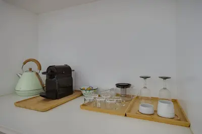 a tray with glasses and a coffee maker and a toaster at SUNSET VILLA - Luxury villa with superb pool and great views in Faro