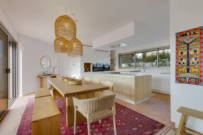 a kitchen and dining room with a table and chairs at SUNSET VILLA - Luxury villa with superb pool and great views in Faro