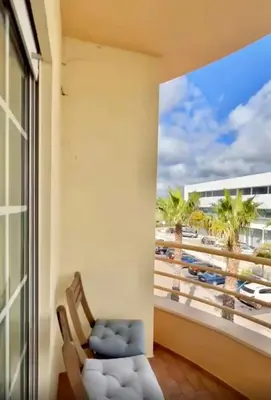 a balcony with a chair and a view of a beach at Casa do Mar Faro in Faro