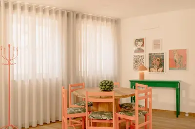 a dining room with a table and four chairs at Glam House no coração da cidade in Faro