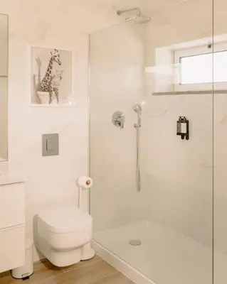 a white bathroom with a toilet and a shower at Glam House no coração da cidade in Faro