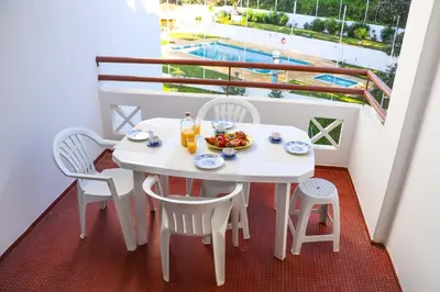 two beds with white blankets and pillows in a room at Apartment - Sleeps 2 Parking & Pool Access in Albufeira