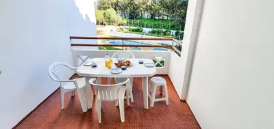 a living room with a couch and a tv at Apartment - Sleeps 2 Parking & Pool Access in Albufeira