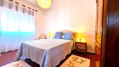 a bedroom with a bed and a window at Apart Alfarrobinha - T2 - BY BEDZY in Tunes
