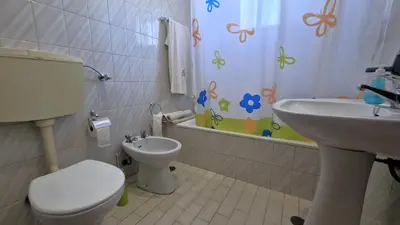 a bathroom with a toilet and a sink at Apart Alfarrobinha - T2 - BY BEDZY in Tunes