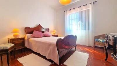 a bedroom with a large bed and a window at Apart Alfarrobinha - T2 - BY BEDZY in Tunes