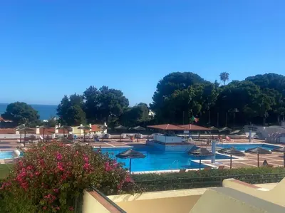 a view of a resort with chairs and flowers at Bella Home in Albufeira
