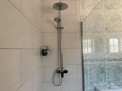 a bathroom with a sink and a toilet and a mirror at BnB Homes Luxurious Villa Stardust with Swimming pool & BBQ for Family Fun in Ameijoafas