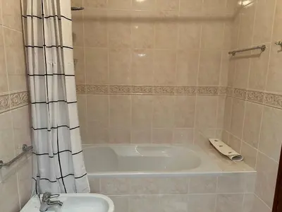 a bathroom with a sink and a toilet and a mirror at BnB Homes Luxurious Villa Stardust with Swimming pool & BBQ for Family Fun in Ameijoafas