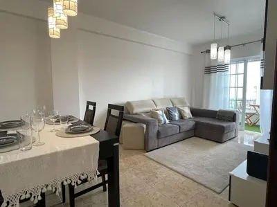 a living room with a couch and a table at The Luna Apartment Faro - 2 Bedroom Private Apartment in Faro
