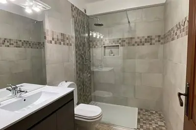 a bathroom with a sink and a toilet and a shower at The Luna Apartment Faro - 2 Bedroom Private Apartment in Faro