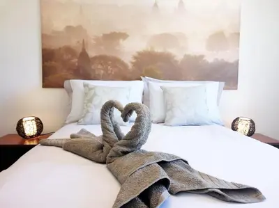 two towel swans sitting on top of a bed at The Luna Apartment Faro - 2 Bedroom Private Apartment in Faro