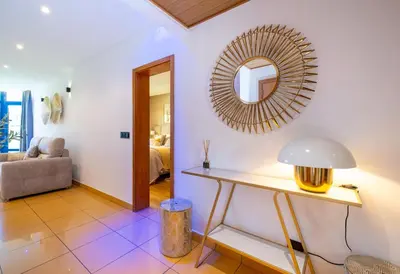 a living room with a table and a mirror at Romantic with private Hot Tub & Parking - big pool - Marina access in Albufeira