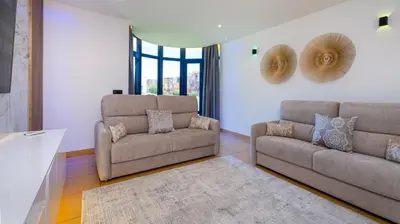 a living room with two chairs and a couch at Romantic with private Hot Tub & Parking - big pool - Marina access in Albufeira