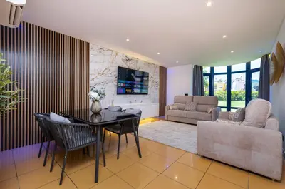 a living room with a table and a couch at Romantic with private Hot Tub & Parking - big pool - Marina access in Albufeira