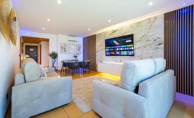 a living room with two chairs and a television at Romantic with private Hot Tub & Parking - big pool - Marina access in Albufeira