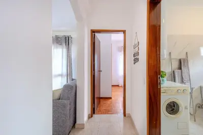 a hallway with a living room and a laundry room at Apartamento Briza by Sunnyway in Albufeira