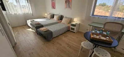 a small bedroom with a bed and a table and chairs at Ideal Bubble House in Faro