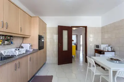 a kitchen with a counter and a table and chairs at Color me Happy - 2 bedrooms apartment near Forum Algarve in Faro