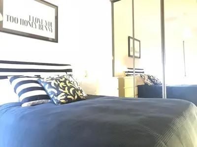 a bedroom with a bed with blue sheets and pillows at Home away from Home in Faro