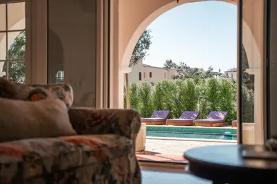 a living room with couches and a swimming pool at Luxurious Villa - Pool, Hot Tub, Cinema and Golf in Vilamoura
