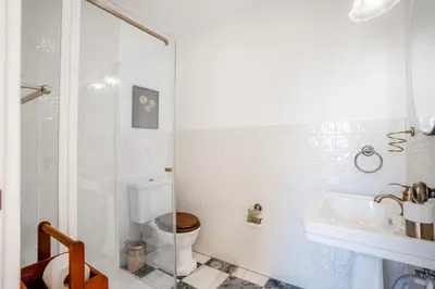 a white bathroom with a toilet and a sink at Luxurious Villa - Pool, Hot Tub, Cinema and Golf in Vilamoura