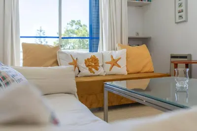 a living room with a couch and a glass table at TAC - Windmill OceanFront Villa in Albufeira