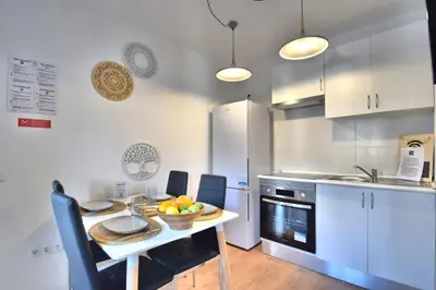 a kitchen with a table with a bowl of fruit on it at Old Town Gem by Atlantic Places in Albufeira