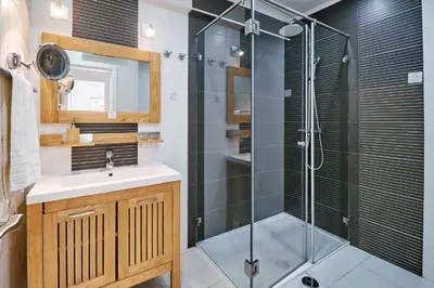 a bathroom with a glass shower and a sink at Apartment Monaco mit Pool in Albufeira