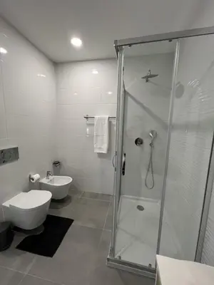 a bathroom with a shower and a toilet and a sink at Casa MarRia in Faro