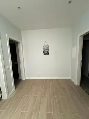 an empty room with white walls and wooden floors at Casa MarRia in Faro