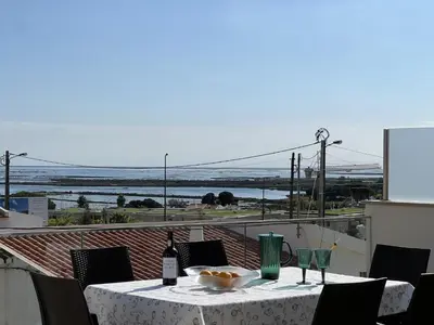 a table with a bowl of food on a balcony at Casa MarRia in Faro