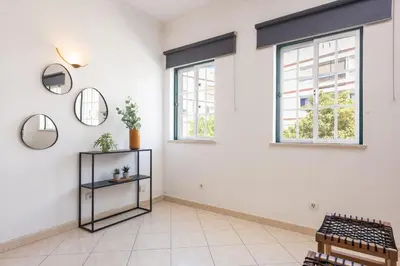 a living room with white walls and windows at Oasis apartment - City center by HD in Faro