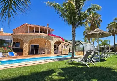 a villa with a swimming pool and a house at Villa Ania - Private Villa with pool&Jacuzzi, 16 to 40 pax in Albufeira