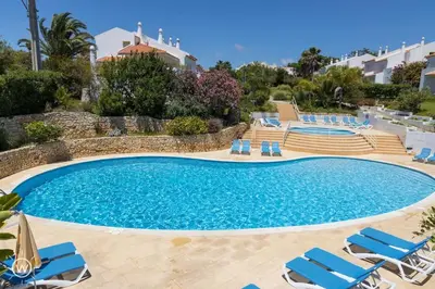 a swimming pool with lounge chairs and a swimming pool at Sunshine Villa Salgados Guia Algarve in Albufeira