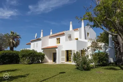 a large white house with a green yard at Sunshine Villa Salgados Guia Algarve in Albufeira