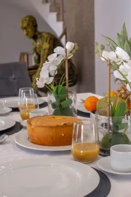 a table with plates and glasses of orange juice at Krystal Bay Villa in Albufeira
