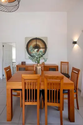 a dining room with a wooden table and chairs at Villa Le petit charme in Albufeira