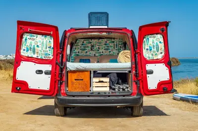 a bedroom in a boat with a bed in it at Ocean Camper - Campervan & Surf rentals in Faro