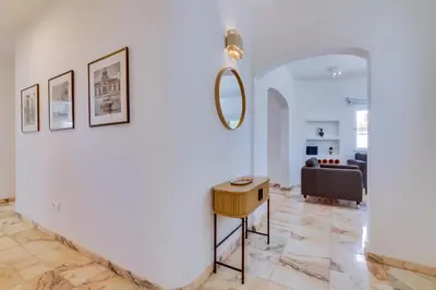 a living room with a table and a couch at Villa Andorra, private pool next to golf in Vilamoura