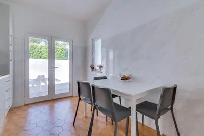 a white dining room with a white table and chairs at Villa Andorra, private pool next to golf in Vilamoura