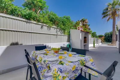 a table with plates on it on a patio at Villa Andorra, private pool next to golf in Vilamoura