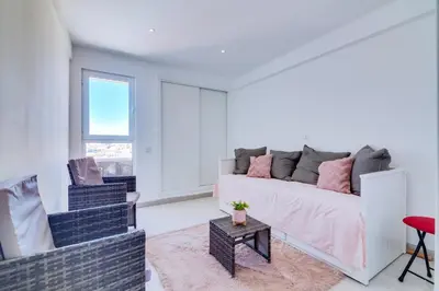 a living room with a couch and a table at 2bdr Sea View Miravila Apartment in Quarteira in Quarteira