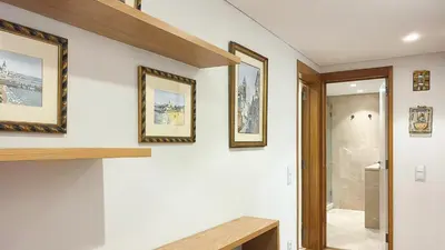 a bathroom with three framed pictures on the wall at Refúgio Sereno Vilamoura T2 by HsR Vilamarina in Quarteira