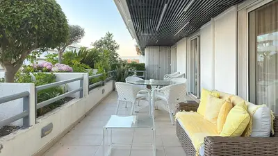 a patio with a table and chairs on a balcony at Refúgio Sereno Vilamoura T2 by HsR Vilamarina in Quarteira