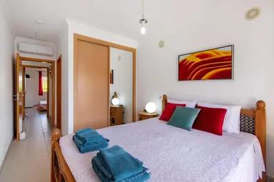 a bedroom with a bed with two towels on it at Encosta São José in Guia
