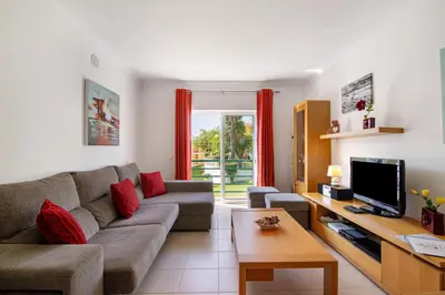 a living room with a couch and a tv at Encosta São José in Guia