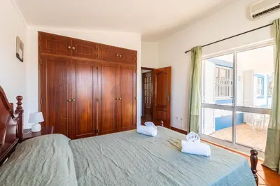 a bedroom with a large bed with two towels on it at Villa Eulália in Guia